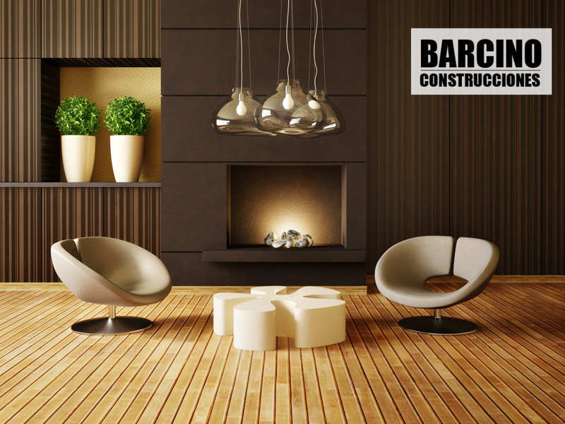 Salón de diseño con dos butacas suelo de madera. Logo de Barcino Diseño de Interiores